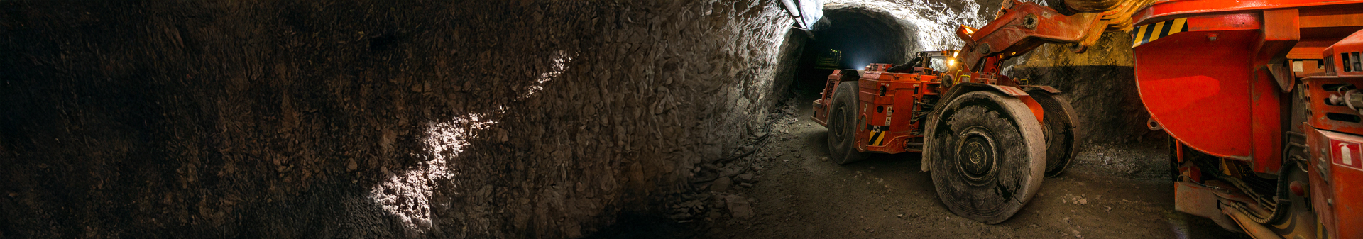 Underground wheel loader fitted with durable underground wheel loader tires operating in a mining tunnel.