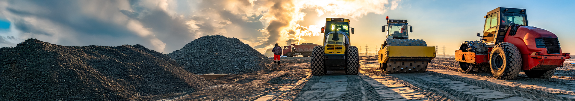 Wheel dozer fitted with durable wheel dozer tires operating at a construction site during sunset.